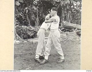 LAE, NEW GUINEA. 1944-09-21. CORPORAL J.L. LEYS (1) AND SERGEANT A.J. DENSMORE (2) OF THE NEW GUINEA FORCE PROVOST COMPANY PRACTICING UNARMED COMBAT