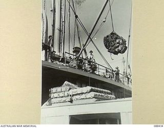 CAIRNS, QUEENSLAND. 1945-03-25. HEADQUARTERS 26 INFANTRY BRIGADE TENTS BEING LOADED ABOARD THE DUTCH VESSEL VAN HEUTSZ DURING EMBARKATION TO MILNE BAY