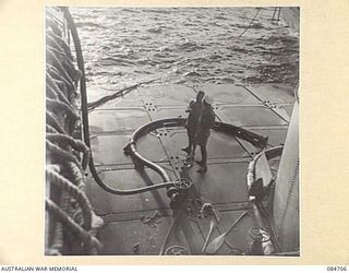 MIOS WUNDI, DUTCH NEW GUINEA. 1944-11-18. A WATER TANK BARGE ALONGSIDE HMAS BINGERA PROVIDING WATER