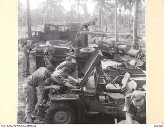 ALEXISHAFEN, NEW GUINEA. 1944-07. PERSONNEL AT HEADQUARTERS 8TH INFANTRY BRIGADE, NORTH ALEXISHAFEN, PROVIDING MAINTENANCE TO JEEPS AND TRUCKS. CONSISTENT OVERHAULS ARE NECESSARY TO MEET THE HEAVY ..