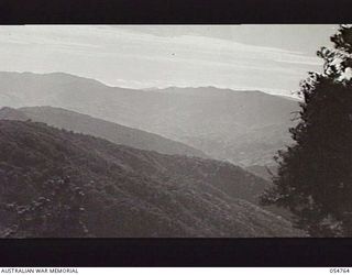 BULLDOG ROAD, NEW GUINEA, 1943-07-20. VIEW FROM JOHNSON GAP, LOOKING TOWARDS EDIE CREEK, SHOWING TYPE OF RUGGED COUNTRY CONQUERED BY THE ROAD BUILDERS