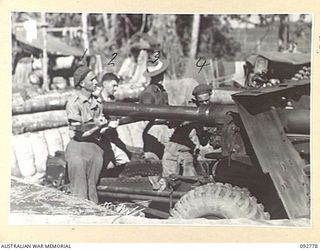 SORAKEN, BOUGAINVILLE. 1945-06-05. MEMBERS OF 4 FIELD REGIMENT REPLACING A 25-POUNDER GUN BARREL INTO ITS JACKET AFTER EXAMINATION. THIS IS USUALLY DONE EVERY 3 MONTHS. IDENTIFIED PERSONNEL ARE:- ..