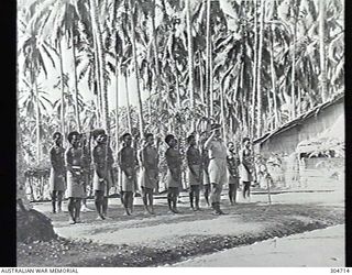 GUADALCANAL, BRITISH SOLOMON ISLANDS PROTECTORATE. 1944-01-25.A GUARD OF HONOUR OF SOLOMONS ISLANDS NATIVE HEADMEN AND POLICE BOYS, LED BY THE AUSTRALIAN DISTRICT OFFICER, CAPTAIN F MOORE, ..