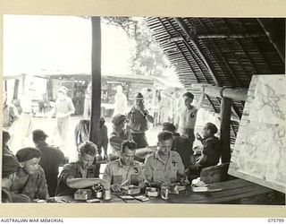 SIAR-NAGADA, NEW GUINEA. 1944. A MESS PARADE FOR PERSONNEL OF A COMPANY, 61ST INFANTRY BATTALION, "THE QUEENSLAND CAMERON HIGHLANDERS", AT THE NATIVE VILLAGE OF NOBINOB. IDENTIFIED PERSONNEL ARE:- ..