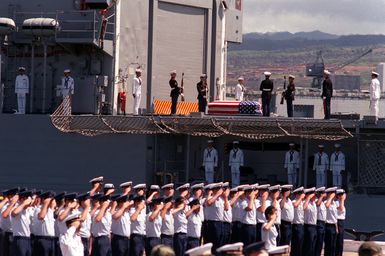 Upon the completion of ceremonies, the flag draped casket of the Unknown Soldier of the Vietnam War is saluted after being carried onto the frigate USS BREWTON (FF 1086). The casket will be transported to Alameda, California, and then transferred to its final destination at the Tomb of the Unknown Soldier, Arlington National Cemetery, Virginia