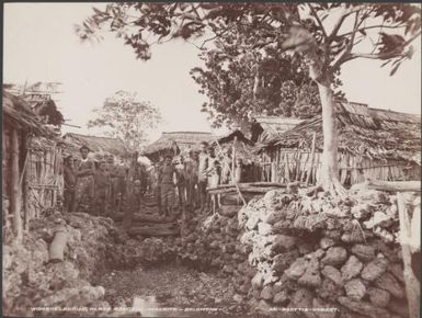 Men and children at the womens landing place of Adegege, Malaita, Solomon Islands, 1906 / J.W. Beattie