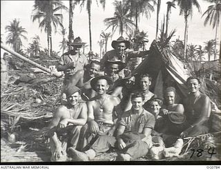 LOS NEGROS ISLAND, ADMIRALTY ISLANDS. 1944-03-18. INFORMAL GROUP PORTRAIT OF GROUND CREWS OF A RAAF KITTYHAWK SQUADRON AROUND FOXHOLES THEY DUG ON THE FIRST NIGHT THEY LANDED WHEN THE BATTLE FOR ..