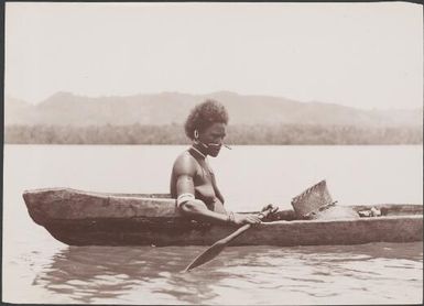 Woman from Port Adam in a canoe, Malaita, Solomon Islands, 1906 / J.W. Beattie