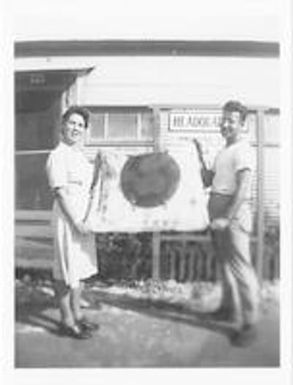 Lucy Slade Libby holds Japanese surrender flag