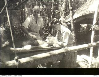 Soputa, Papua. Major T. H. Ackland, surgeon, and Captain A. R. Wakefield, anaesthetist, performing an operation on a patient