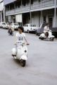 French Polynesia, people riding scooters in Papeete