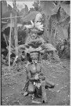 Pig festival, wig ritual: decorated men with large feather headdresses, face paint