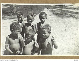 PA PA, PAPUA. 1943-12-02. SMALL NATIVE CHILDREN ENJOYING SOME BISCUITS