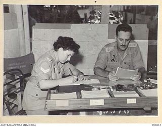 LAE, NEW GUINEA. 1945-05-15. CORPORAL M. HARVEY (1), TAKING DICTATION FROM LIEUTENANT COLONEL K. DAWSON (2), THE ASSISTANT ADJUTANT GENERAL, A BRANCH, HEADQUARTERS FIRST ARMY. A FEW DAYS AFTER ..