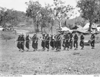 POM POM VALLEY, NEW GUINEA. 1943-11-27. THE BAND OF THE 18TH AUSTRALIAN INFANTRY BRIGADE MARCHING ON TO THE PARADE GROUND FOR THE TAKING OF A TRAINING FILM FOR THE AUSTRALIAN ARMY