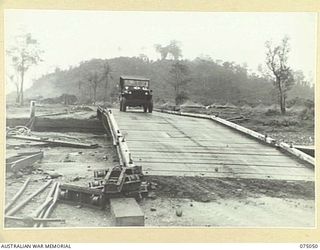 LAE, NEW GUINEA. 1944-08-09. THE RECENTLY COMPLETED STEEL BRIDGE ACROSS THE BUTIBUM RIVER BUILT BY TROOPS OF THE 20TH FIELD COMPANY, TO REPLACE THE OLD WOODEN ONE WHICH WAS WASHED AWAY DURING THE ..