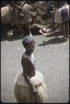 Mortuary ceremony: mourning woman, wearing tiered fiber skirt, is marked with talcum powder