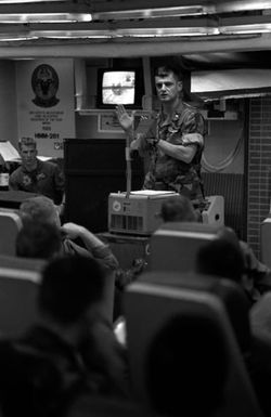 The commanding officer of Marine Medium Helicopter Squadron 261 (HMM-261) delivers a pre-operation briefing to his officers in the squadron ready room aboard the amphibious assault ship USS SAIPAN (LHA 2). The SAIPAN is on station off the coast of Liberia for Operation Sharp Edge