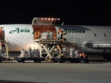 The first batch of the remaining 306 transformers arriving at the Saipan International Airport. The transformers were loaded on six trucks at Solomon headquarters in Solomon, Kansas and then flown to Saipan on Boeing 727s in a series of five flights.