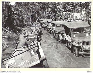 BOUGAINVILLE. 1945-07-21. JEEPS OF 29 INFANTRY BRIGADE CARRYING STORES WEST OF THE OGORATA RIVER AND A TRACTOR TRAIN TRAVELLING IN THE OPPOSITE DIRECTION MEET ON THE NARROW BUIN ROAD, WHICH DUE TO ..