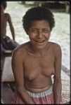 Smiling woman, Mogiovyeka's wife, sitting on a veranda