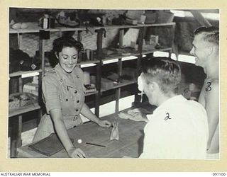 TOROKINA, BOUGAINVILLE. 1945-04-19. MISS L.D. DAVIES, ASSISTANT SUPERINTENDENT (1), AND PATIENTS OF 2/1 GENERAL HOSPITAL IN THE RED CROSS HOBBIES ROOM