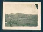 Aeroplane stationed outside a building, [Bulolo Gold Dredging mine, Bulolo?], New Guinea, c1932 to 1933