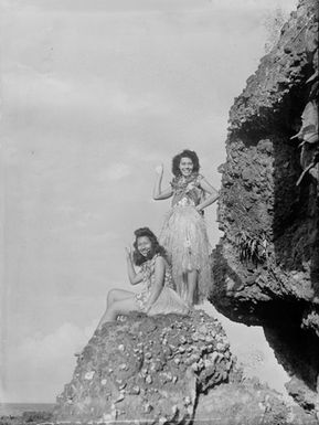 [Portrait of two young Polynesia women on a coastal rock]