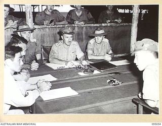 TOKO, BOUGAINVILLE. 1945-08-18. MAJOR OTSU, THE JAPANESE SURRENDER ENVOY (6) AT HEADQUARTERS 3 DIVISION SPEAKING THROUGH AMERICAN INTERPRETERS (1) (2), DURING HIS INTERVIEW WITH BRIGADIER A.R. ..