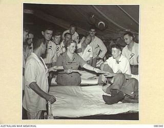 LAE, NEW GUINEA. 1944-08-02. QFX40938 SISTER M.E. DRAKE (1), AT THE 2/7TH GENERAL HOSPITAL, AUSTRALIAN ARMY MEDICAL CORPS, DISTRIBUTING MAIL TO PATIENTS