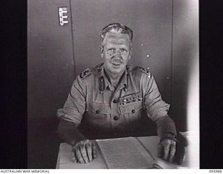 CAPE WOM, WEWAK AREA, NEW GUINEA. 1945-09-01. MAJOR GENERAL H.C.H. ROBERTSON, GENERAL OFFICER COMMANDING 6 DIVISION IN HIS OFFICE AT HEADQUARTERS 6 DIVISION