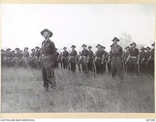 HERBERTON, QUEENSLAND. 1945-03-03. 7 PLATOON, A COMPANY, 2/28 INFANTRY BATTALION, AT HEADQUARTERS 24 INFANTRY BRIGADE ATTENDING A PARADE ON THE RACECOURSE FOR THE PRESENTATION OF TROPHIES BY MAJOR ..