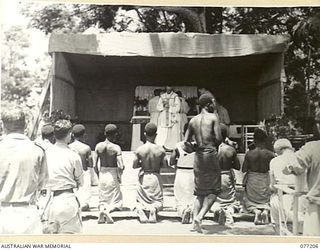 MADANG, NEW GUINEA. 1944-10-29. NEW GUINEA NATIVES ABOUT TO RECEIVE COMMUNION FROM NX142933 CHAPLAIN W.L. CORR DURING A SOLEMN HIGH MASS CELEBRATED ON THE LOCAL SPORTS OVAL