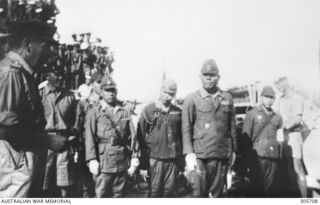NAMATANAI, NEW IRELAND. 1945-09-19. THE SURRENDER OF GENERAL ITO (FIFTH FROM LEFT), COMMANDER IN CHIEF OF JAPANESE FORCES ON NEW IRELAND, TO MAJOR GENERAL K. W. EATHER CB CBE DSO ED, GENERAL ..
