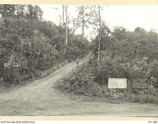 FINSCHHAFEN AREA, NEW GUINEA, 1944-03-20. TWO OF MANY BATTLE SIGNS IN THE FINSCHHAFEN AREA, THE SIGN TO THE LEFT RECORDS THE ACTIVITIES OF THE 2/13TH, 2/15TH, 2/17TH AND 2/43RD INFANTRY BATTALIONS, ..