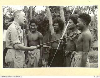 1943-07-16. NEW GUINEA. CAPTAIN CLARRIE MARTIN M.L.A. FOR WAVERLEY AND ATTORNEY GENERAL FOR N.S.W. EXAMINES SPEARS USED BY NATIVES FOR FISHING. CAPT. MARTIN WAS THE FIRST CABINET MINISTER IN THE ..