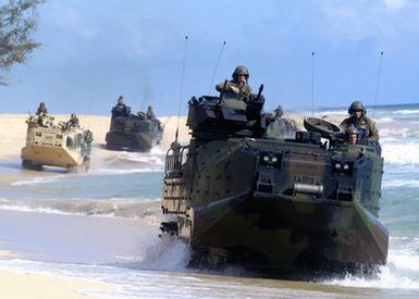 US Marine Corps (USMC) Marines assigned to the 3rd Amphibious Assault Battalion (AAB), Marine Corps Base (MCB) Camp Pendleton, California (CA), tread along the shoreline onboard AAV7A1 Assault Amphibian Vehicles during an amphibious training exercise at the Pacific Missile Range Facility (PMRF), Hawaii (HI)