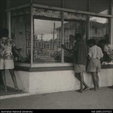 Men looking through shop window