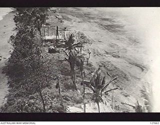 DAGUA, NEW GUINEA. 1943-08-30. LOW LEVEL RUN BY LIBERATORS OF FIFTH AIR FORCE, UNITED STATES ARMY AIR FORCE, ON DAGUA AIRSTRIP. FIGHTERS ARE DISPERSED ALONG REVETMENTS AT WATERS EDGE