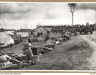 PORT MORESBY, PAPUA, NEW GUINEA. 1944-01-05. TROOPS OF THE 58/59TH AUSTRALIAN INFANTRY BATTALION, 15TH AUSTRALIAN INFANTRY BRIGADE, WITH THEIR EQUIPMENT PACKED, EMBUSSING FOR THEIR AIRLIFT TO ..