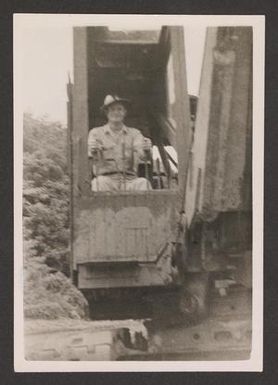 [Henry J. Cates Sitting Inside Construction Vehicle]
