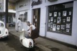 French Polynesia, woman parking scooter on Papeete street