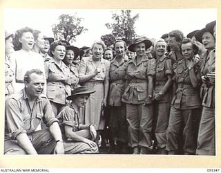 TOROKINA, BOUGAINVILLE, 1945-08-16. THE ENGLISH SINGER GRACIE FIELDS (1) SINGING "WISH ME LUCK AS YOU WAVE ME GOOD-BYE" WITH AUSTRALIAN ARMY NURSING SERVICE SISTERS OF 2/1 GENERAL HOSPITAL