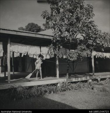 Boy sweeping veranda