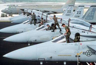 Maintenance personnel and flight crews from the 18th Tactical Fighter Wing preflight some of the squadron's F-15 Eagle aircraft during Exercise Giant Warrior '89. The aircraft third from front is an F-15D Eagle, the others are F-15C Eagles