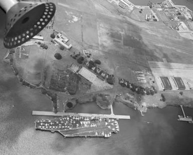 A vertical view of the nuclear-powered aircraft carrier USS CARL VINSON (CVN 70) moored to a pier during Exercise RIMPAC '86