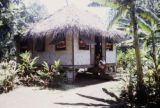 French Polynesia, women sitting on steps of home on Tahiti Island