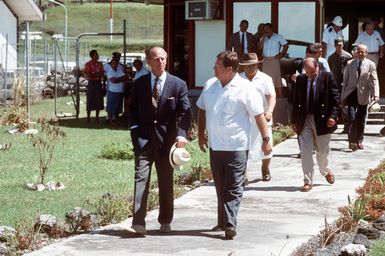 Prince Philip of England converses with William Francisco, charge d'affaires, during a walking tour. The prince is visiting the islands to determine damage sustained from Cyclone Ofa