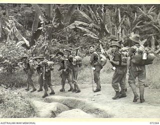 YAULA, NEW GUINEA. 1944-04-08. A SECTION FROM C COMPANY, 57/60TH INFANTRY BATTALION, MOVING TO A FORWARD POSITION NORTH OF YAULA, A FEW MILES FROM BOGADJIM. IDENTIFIED PERSONNEL ARE:- V122194 ..