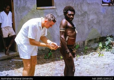 Ian Taylor and stick, APBM, Malekula (New Hebrides)